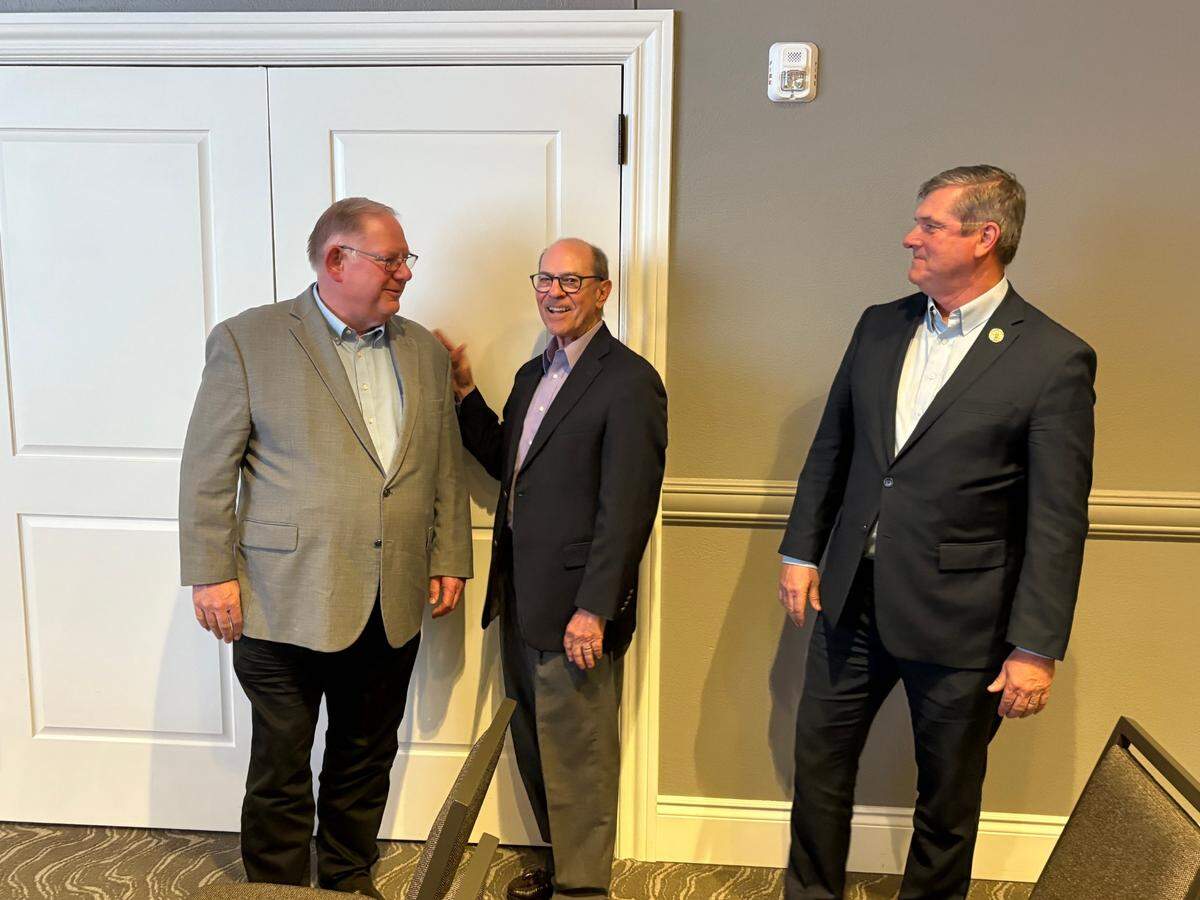 Steve Brunk (center) stands with Kansas Speaker of the House Dan Hawkins (left) and Majority Leader Chris Croft after being selected by Republican precinct committee people to serve the remainder of Patrick Penn’s term in House District 85.