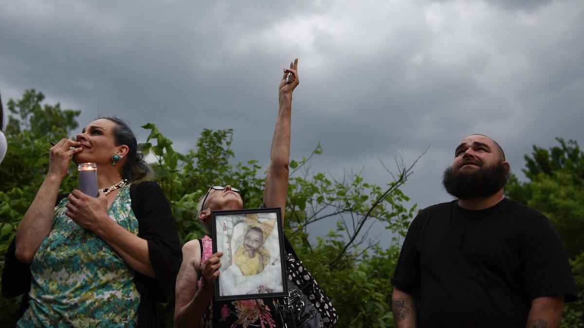 Ruthann Hickman, Robin Davis and Tristin Stewart look to the sky during a balloon release on June 2, 2023, for 6-month-old Kha’liya Bridgewater, whose body was found in May in east Kansas City.