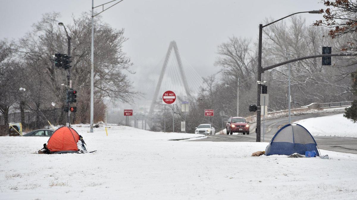People without homes set up tents on the median of The Paseo Wednesday, Feb. 10, 2021. This week, high temperatures will get into the single digits.