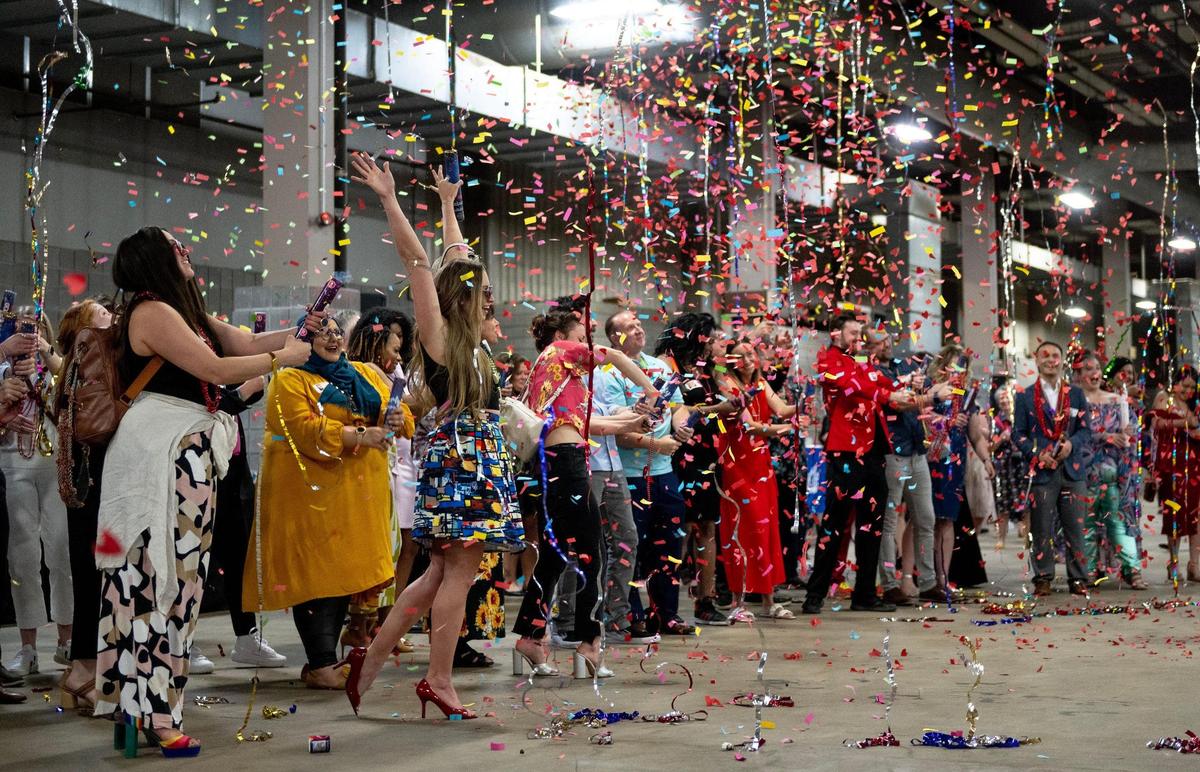 Artists celebrate with confetti canons during the Parade of Hearts Reveal Kickoff Event on Friday, April 14, 2023, in Kansas City.