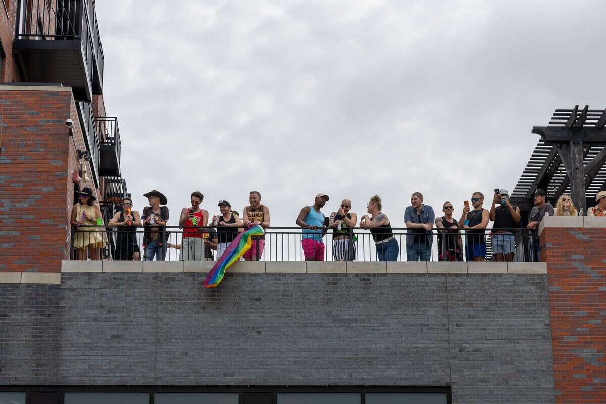 An apartment rooftop lined with parade watchers during Kansas City's Annual Pride Parade at Westport Rd on Saturday, June 6, 2026.