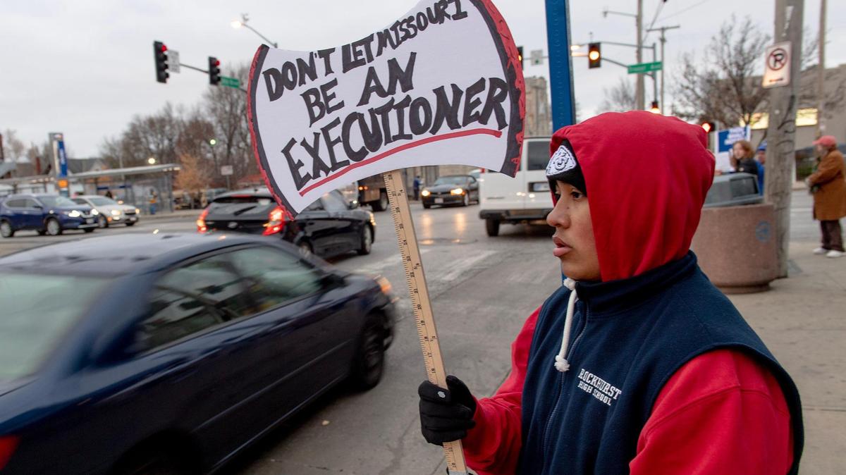 Julian Garcia, a senior at Rockhurst High School, protests the planned execution of Missouri prisoner Kevin Johnson on Tuesday, Nov. 29, 2022, in Kansas City.