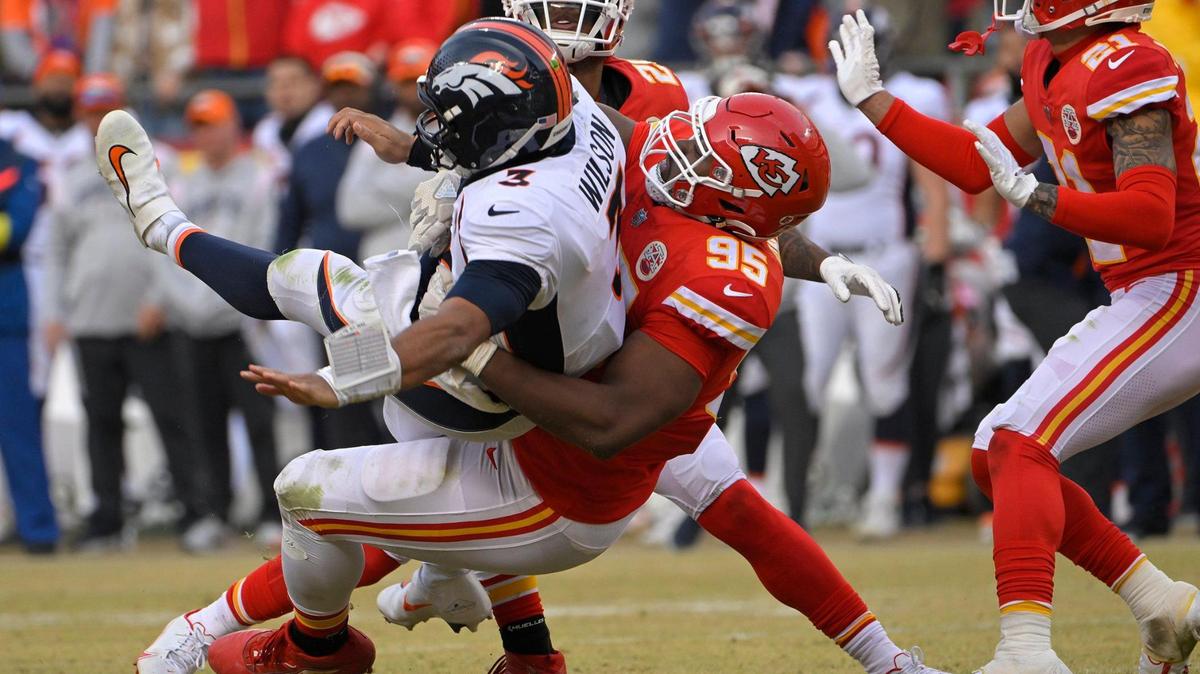 Kansas City Chiefs defensive tackle Chris Jones (95) pulls down Denver Broncos quarterback Russell Wilson (3) on a fourth down play with the Broncos threatening to score late in the second-half Sunday, Jan. 1, 2023, at GEHA Field at Arrowhead Stadium in Kansas City. The Chiefs defeated the Broncos, 27-24.