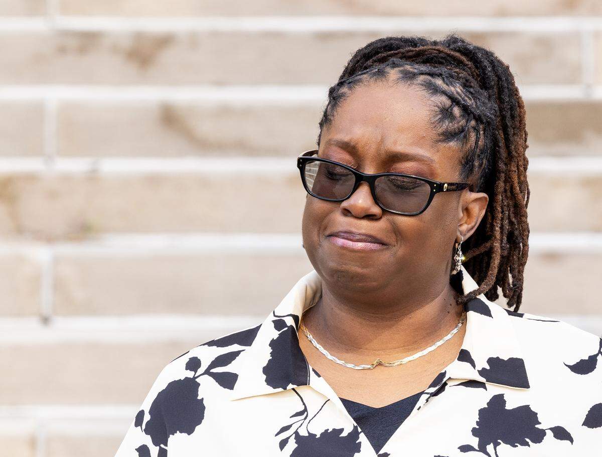 LaTasha Crawford, the sister of Kenneth Williams Jr., pauses in a moment of grief during a press conference outside the Jackson County Courthouse in downtown Kansas City on Friday, Oct. 3. Prosecutors announced Friday that they would not file criminal charges against the Raytown police officer who fatally shot Williams in November.