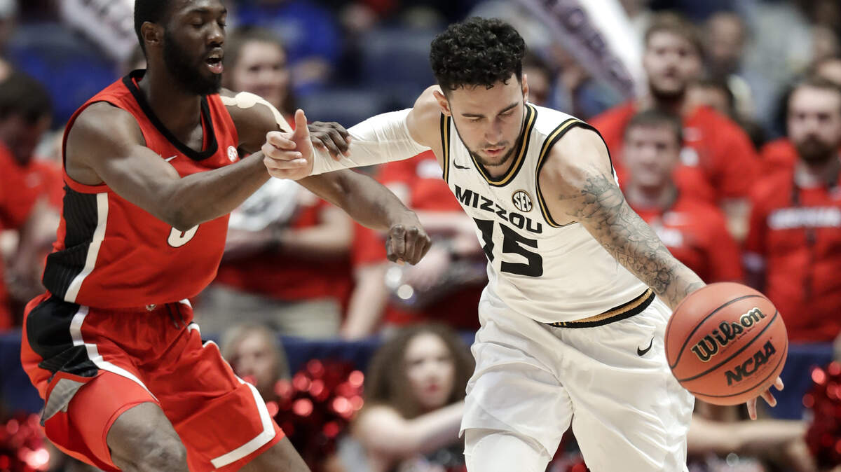 Georgia guard William Jackson II, left, fouls Missouri guard Jordan Geist (15) in the second half of an NCAA college basketball game at the Southeastern Conference tournament, Wednesday, March 13, 2019, in Nashville, Tenn. Missouri won 71-61. (AP Photo/Mark Humphrey)