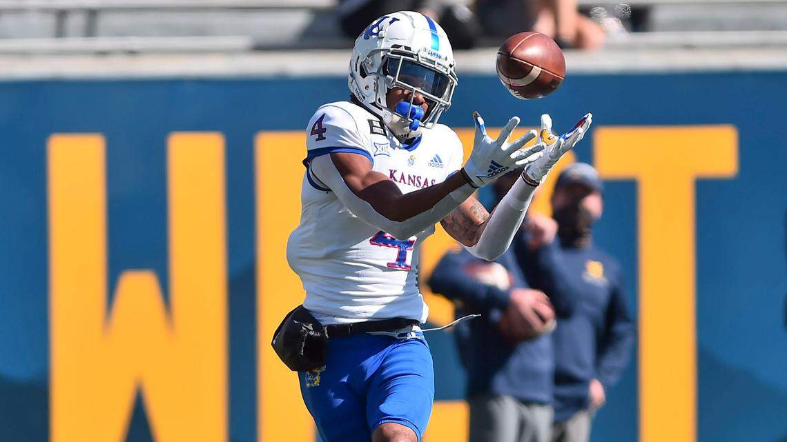 Kansas wide receiver Andrew Parchment (4) makes a catch and runs in for a touchdown against West Virginia during an NCAA college football game Saturday, Oct. 17, 2020, in Morgantown, W.Va. (William Wotring/The Dominion-Post via AP)
