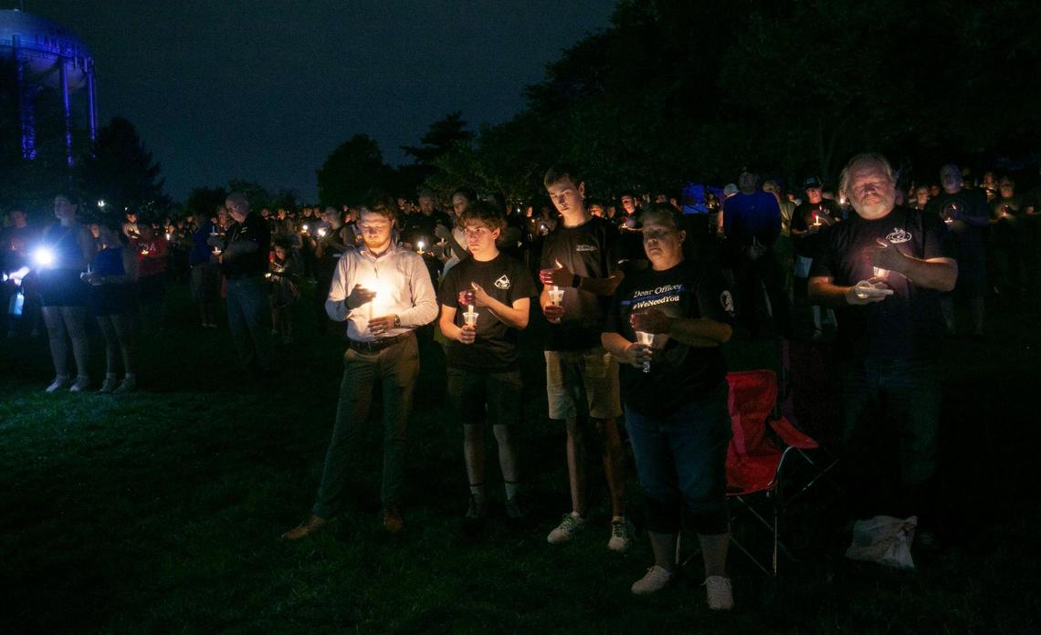 Law enforcement and first responders, as well as community members, gathered Saturday night at Harmon Park in Prairie Village for a candlelight vigil in honor of fallen Fairway police officer Jonah Oswald.
