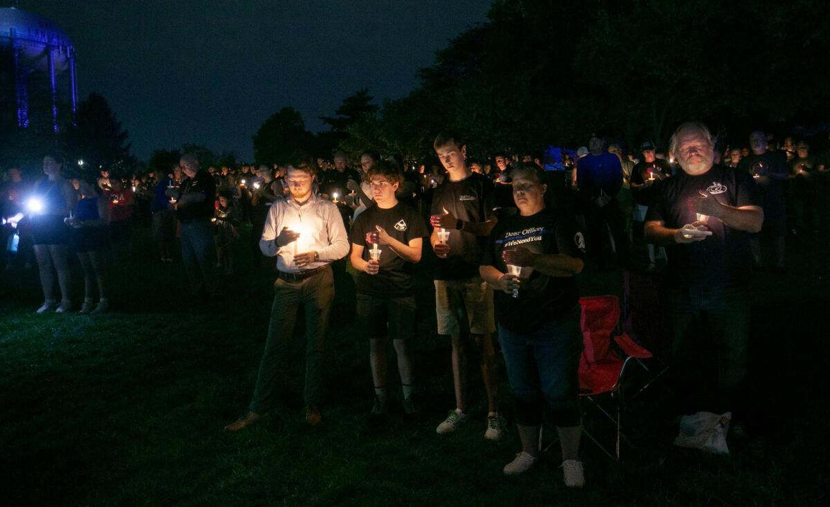 Law enforcement and first responders, as well as community members, gathered Saturday night at Harmon Park in Prairie Village for a candlelight vigil in honor of fallen Fairway police officer Jonah Oswald.