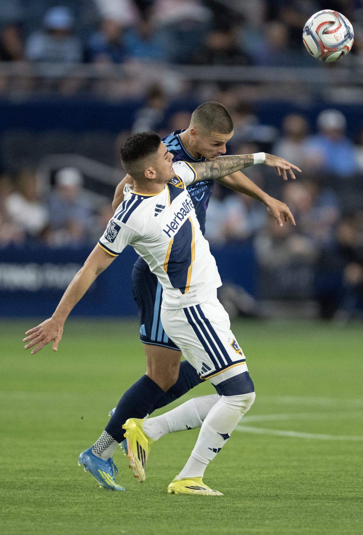 LA Galaxy midfielder Gabriel Pec (11) and Sporting Kansas City forward Dejan Joveljic (9) compete for the ball in the second half at Sporting Park on Wednesday, May 13, 2026, 2026, in Kansas City, Kansas. Sporting KC defeated the LA Galaxy, 3-1.