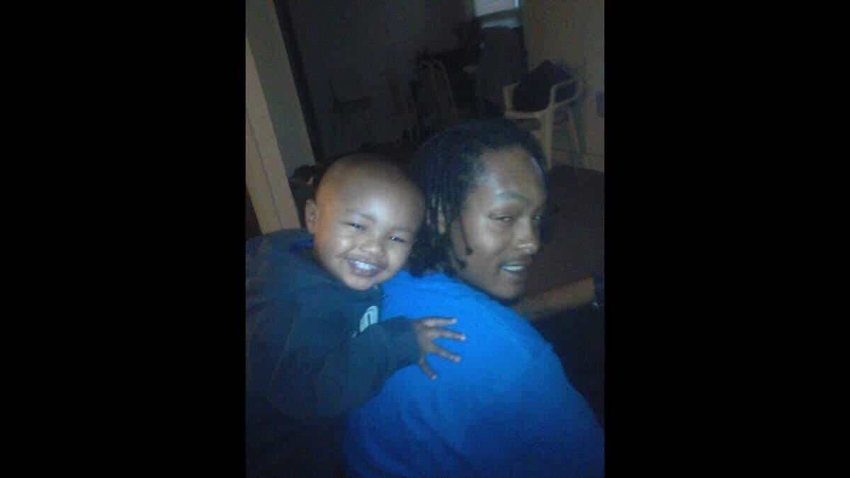 Shawndele Gray, a loving father, poses with one of his six children, Shawndele Gray Jr.