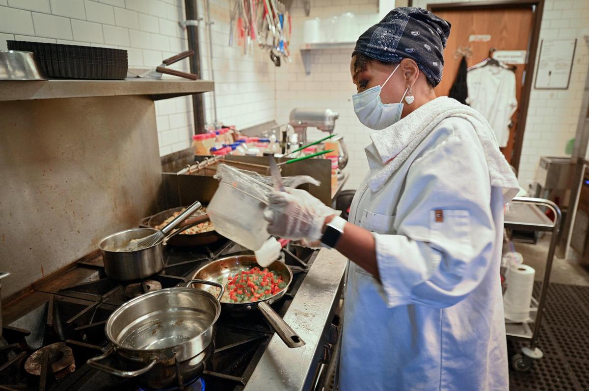 Chef Kim Cole, who specializes in homestyle French cuisine, cooks an order at her Foodlove Cafe.