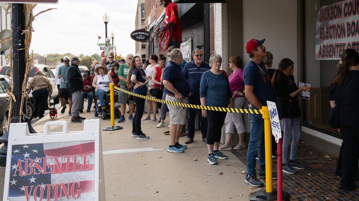 Voters form a line that snakes around the block during early voting at the Jackson County Election Board polling station in Independence on Tuesday, Oct. 29. Some voters waited up to three hours to cast their vote.
