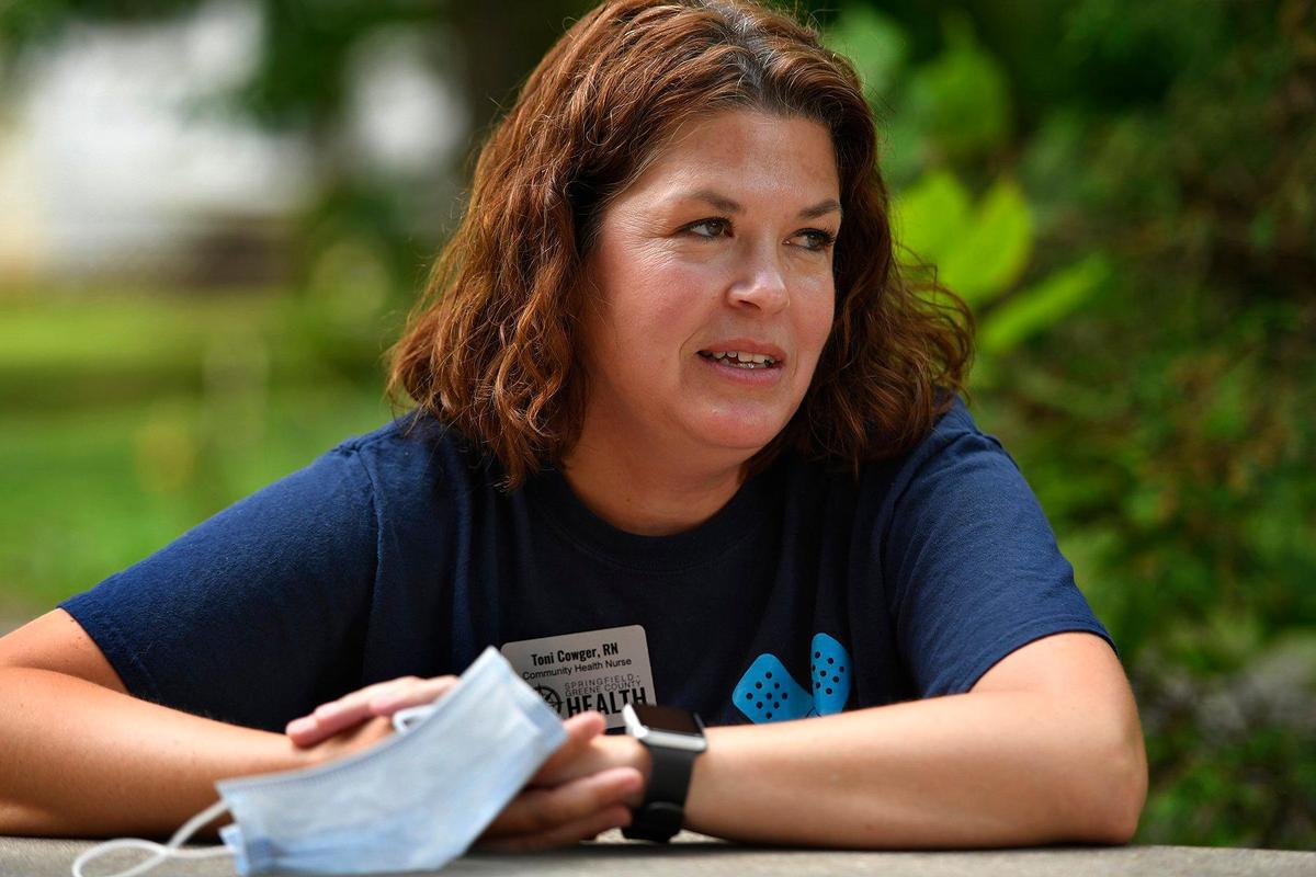 Toni Cowger, a community health nurse with the Springfield-Greene County Health Department, fought back her emotions as she helped residents who decided to get vaccinated at a clinic on Thursday at Fire Station No. 1. Only a day earlier, Cowger attended the funeral of a relative, a 32-year-old mother of two boys, who died of COVID-19 and had refused to get vaccinated.