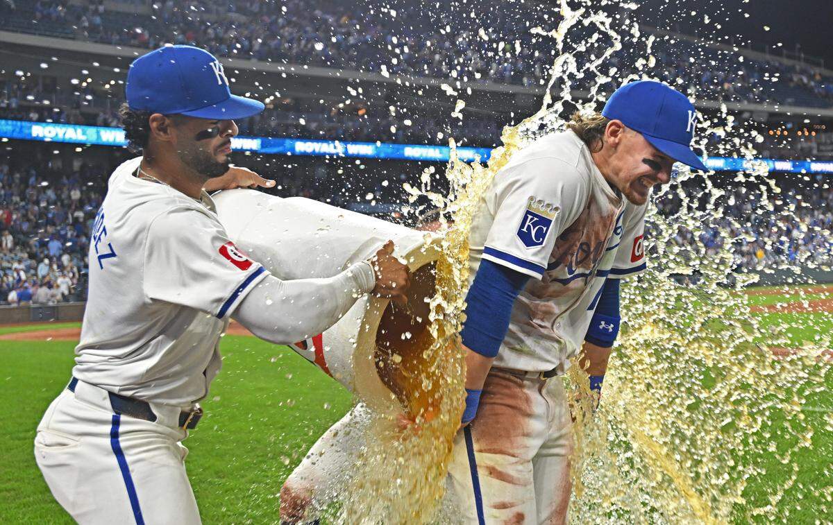 Kansas City Royals shortstop Bobby Witt Jr. (7) gets doused with the QT Big Cup by teammate MJ Melendez (left) after beating the Minnesota Twins at Kauffman Stadium on Sept. 7, 2024.
