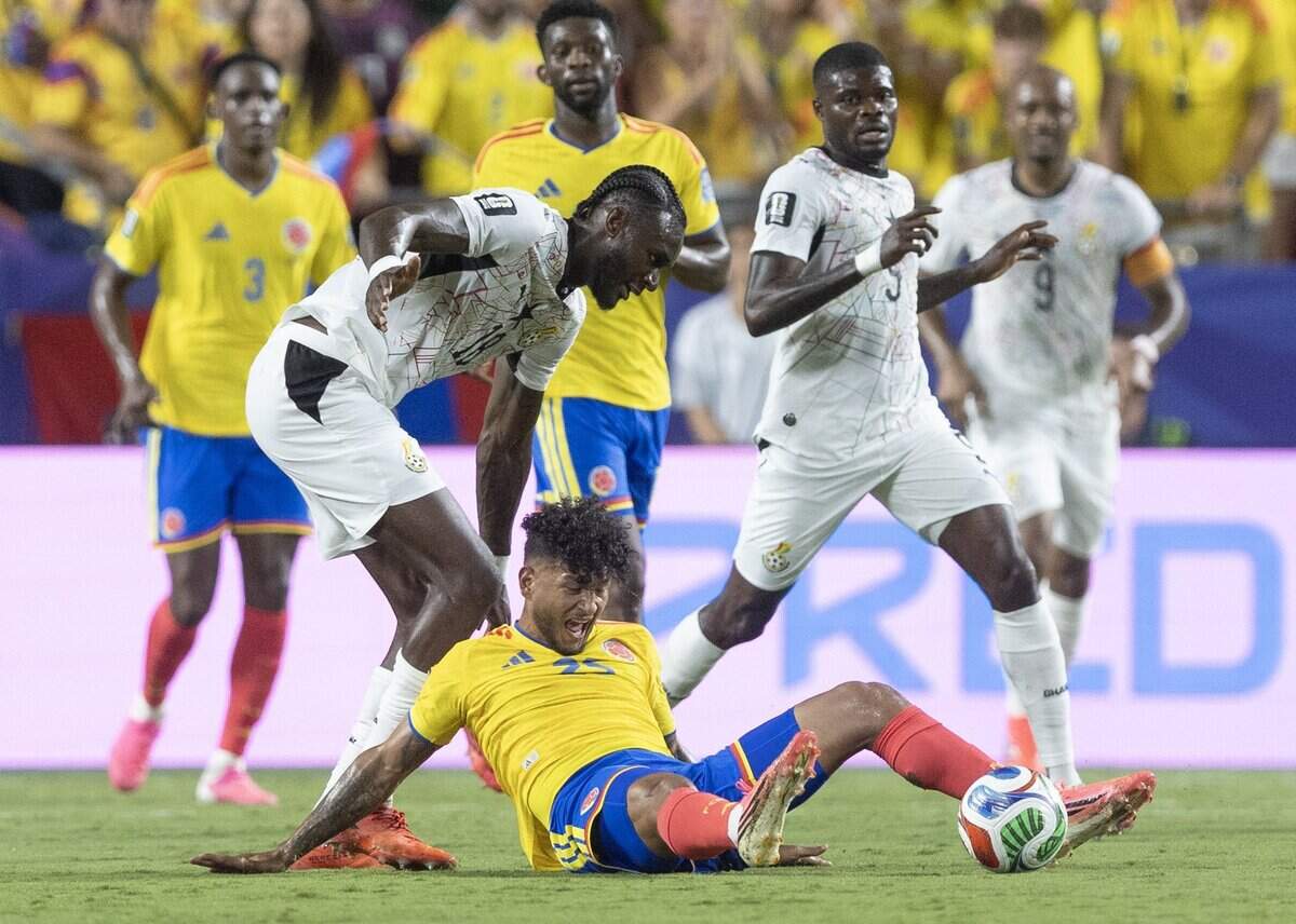 Colombia forward Luis Suárez (25) is pulled to the ground by Ghana defender Jerome Opoku (18) during a FIFA World Cup knockout stage soccer match at Kansas City (Arrowhead) Stadium in Kansas City on Friday, July 3, 2026.