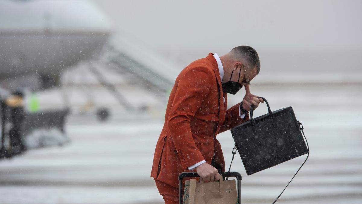 Kansas City Chiefs tight end Travis Kelce adjusted his sunglasses as he walked across the tarmac at Kansas City International Airport Saturday to join his teammates on a plane going to Tampa, Florida, where the Chiefs will play in Super Bowl LV.