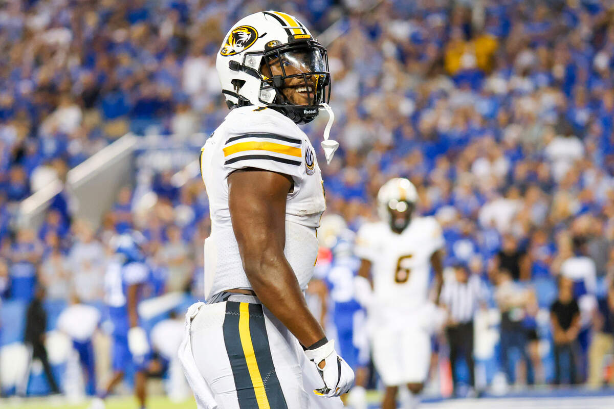 Missouri running back Tyler Badie (1) celebrates scoring a touchdown during a NCAA college football game against Kentucky in Lexington, Ky., Saturday, Sept. 11, 2021. (AP Photo/Michael Clubb)