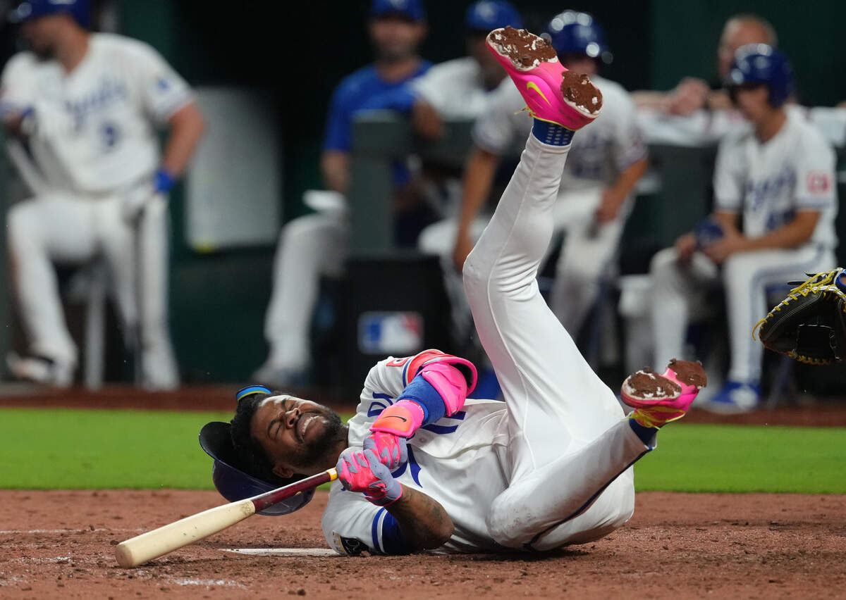 Kansas City Royals third baseman Maikel Garcia falls to the ground after swinging at a pitch against the Texas Rangers in the eighth inning at Kauffman Stadium on June 10, 2026 in Kansas City, Missouri.