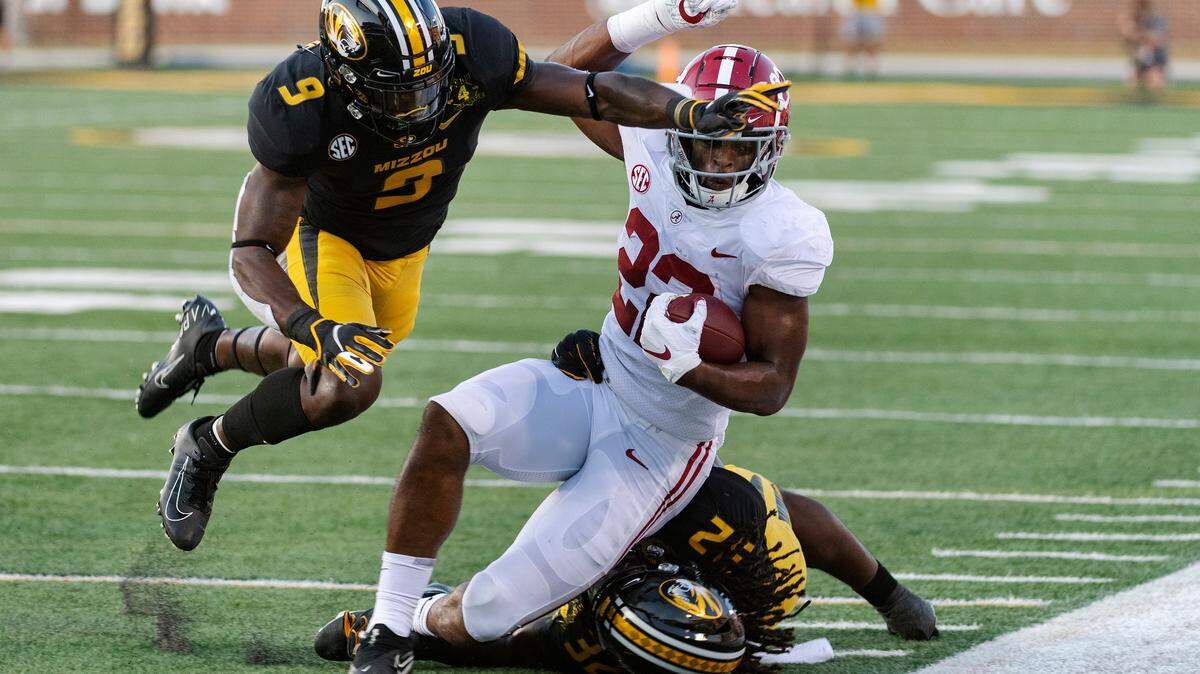 Alabama’s Najee Harris, center, is knocked out of bounds by Missouri’s Tyree Gillespie, left, and Aubrey Miller Jr., right, during the first quarter of an NCAA college football game Saturday, Sept. 26, 2020, in Columbia, Mo. (AP Photo/L.G. Patterson)