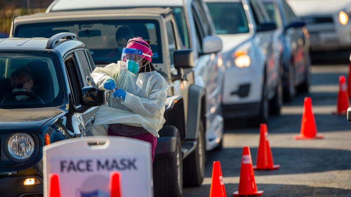 Workers from Swope Health, including Jameisha Carr, a medical assistant, administered COVID-19 tests Wednesday, Nov. 18, 2020, at drive-through clinic at Holmeswood Baptist Church in Kansas City. The site was hoping to test between 150 and 200 people. The testing was run in conjunction with the Kansas City Health Department.