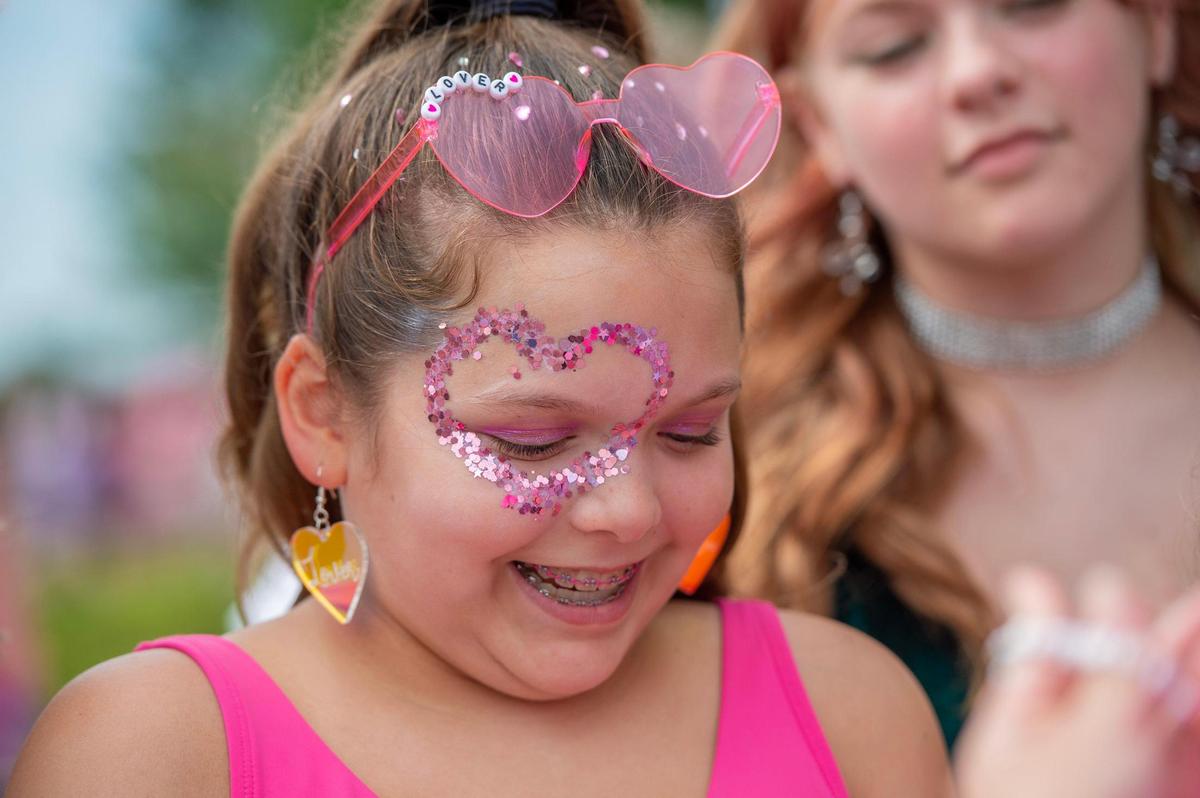 Twelve-year-old Meghan Birnbaum sports heart-shaped sunglasses and a heart around her eye depicting the “Lover” era at Taylor Swift’s Eras Tour stop at GEHA Field at Arrowhead Stadium on Friday, July 7, 2023, in Kansas City.