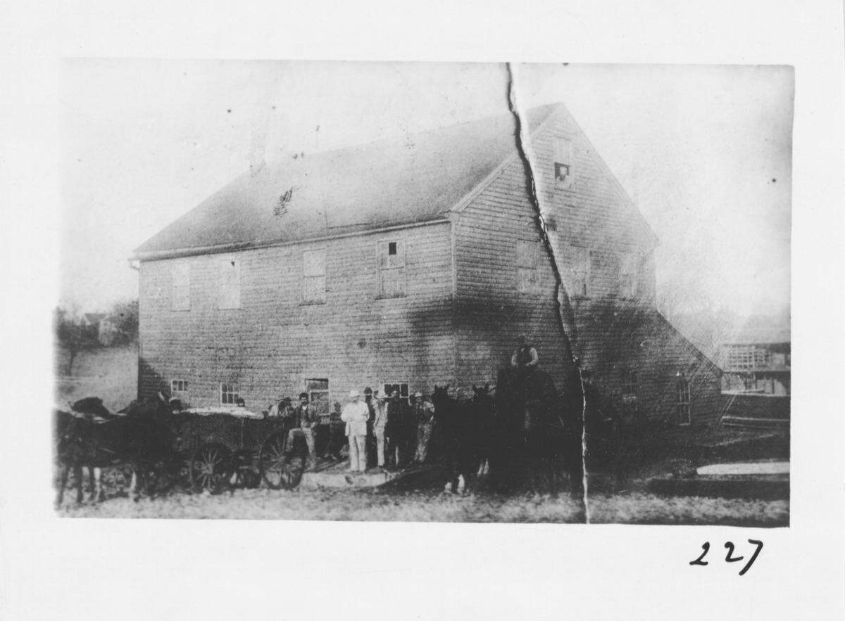 This 1880 photograph shows unidentified men in front of the Westport Mill, which gave its name to the present day Mill Street. Provided by Missouri Valley Special Collections, Kansas City Public Library in Kansas City, Missouri.
