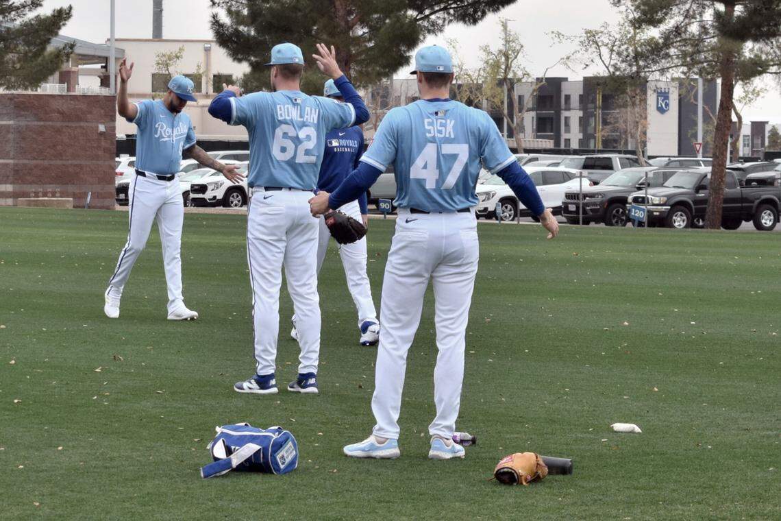 Kansas City Royals pitchers Evan Sisk, Steven Cruz and Jonathan Bowlan stretch ahead of their bullpen session at the Royals spring training complex in Surprise, Arizona on Feb. 12, 2025.