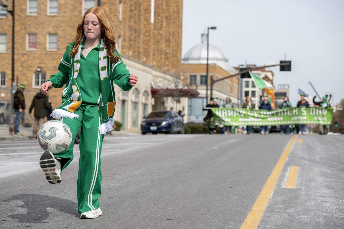 Annie Kane performs tricks with a soccer ball during the St. Patrick's Day parade along Broadway Boulevard on Tuesday, March 17, 2026, in Kansas City.