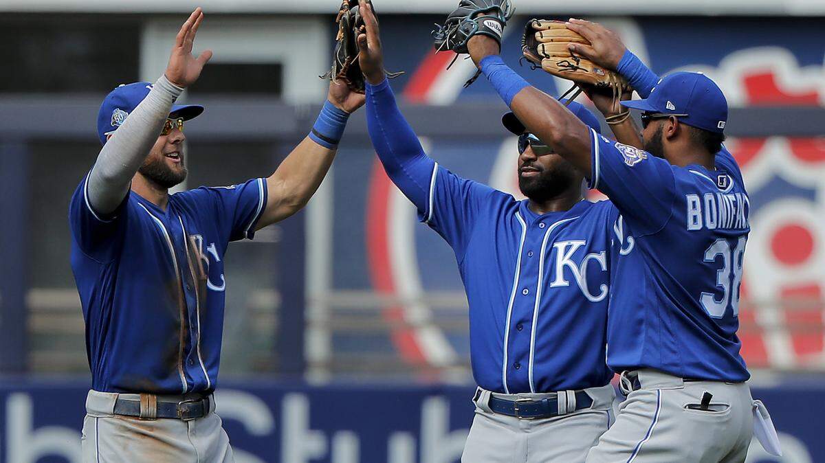 Kansas City Royals left fielder Alex Gordon, left, center fielder Brian Goodwin, center, and right fielder Jorge Bonifacio celebrate after the Royals defeat the New York Yankees 10-5 in the first baseball game of a doubleheader in New York.