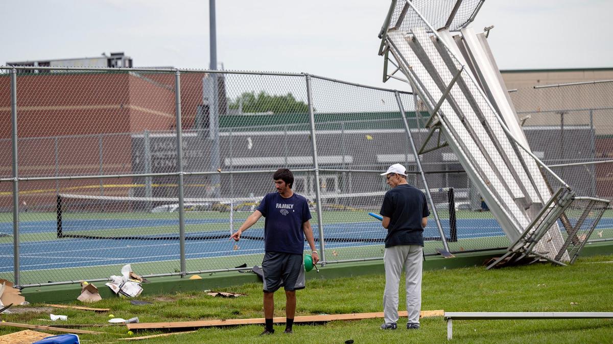 Andrew Bock, left, assistant tennis coach, and his dad, Steve Bock, head tennis coach, were assessing the damage to the tennis courts Monday, May 20, 2024, after a tornado hit Mill Valley High School Sunday night in Shawnee, Kansas.
