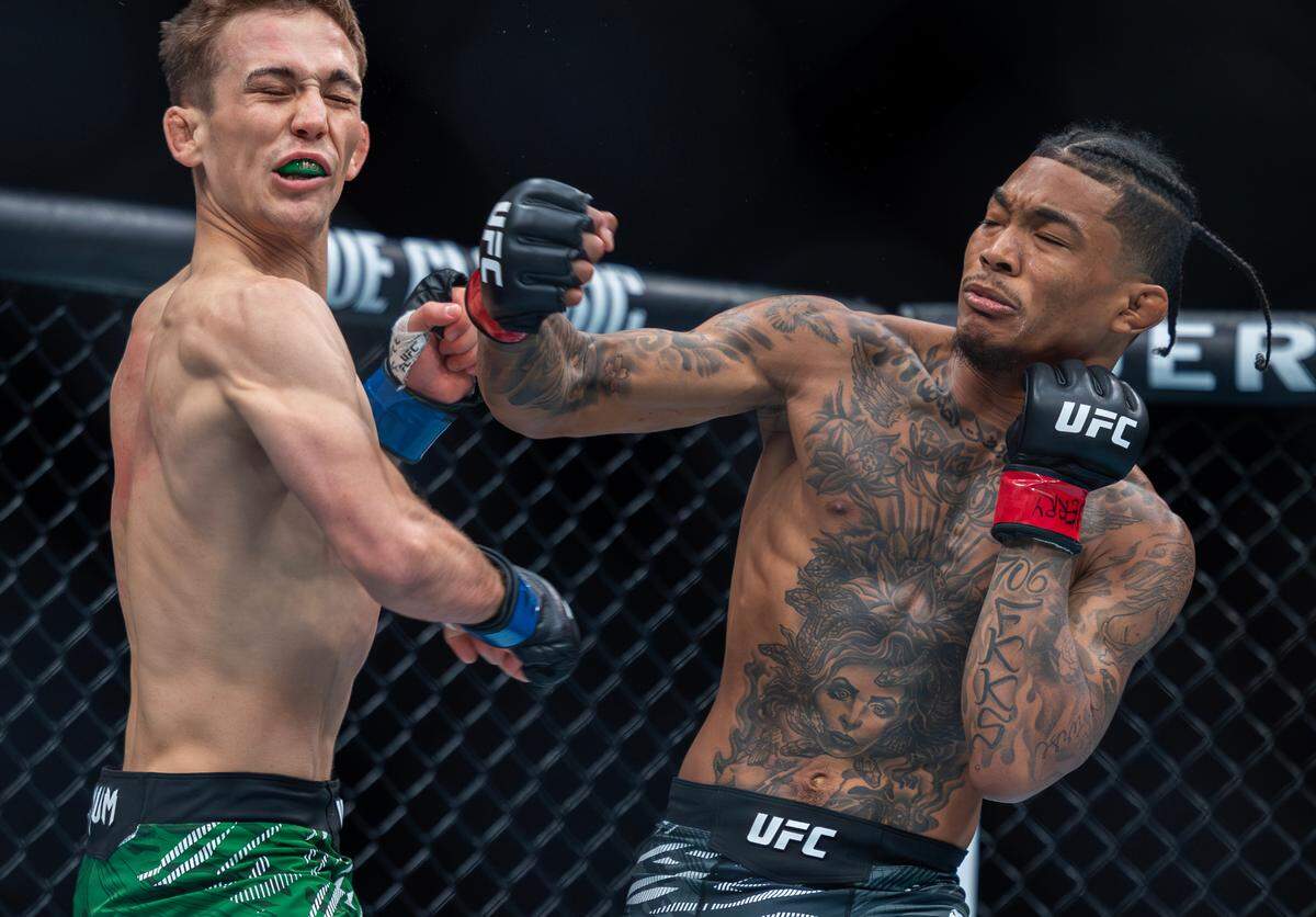 Malcolm Wellmaker lands a punch on fellow bantamweight Cameron Saaiman during their bout at the T-Mobile Center in Kansas City on Saturday night during UFC Fight Night: Machado Garry vs. Prates. Wellmaker went on to win the fight.