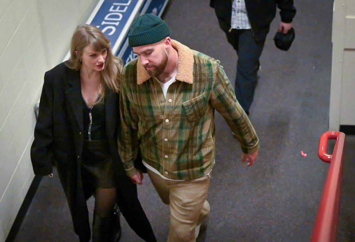 Taylor Swift and Travis Kelce talk as they leave after the Buffalo Bills defeated the Kansas City Chiefs, 20-17, on Sunday, Dec. 10, 2023, at GEHA Field at Arrowhead Stadium in Kansas City