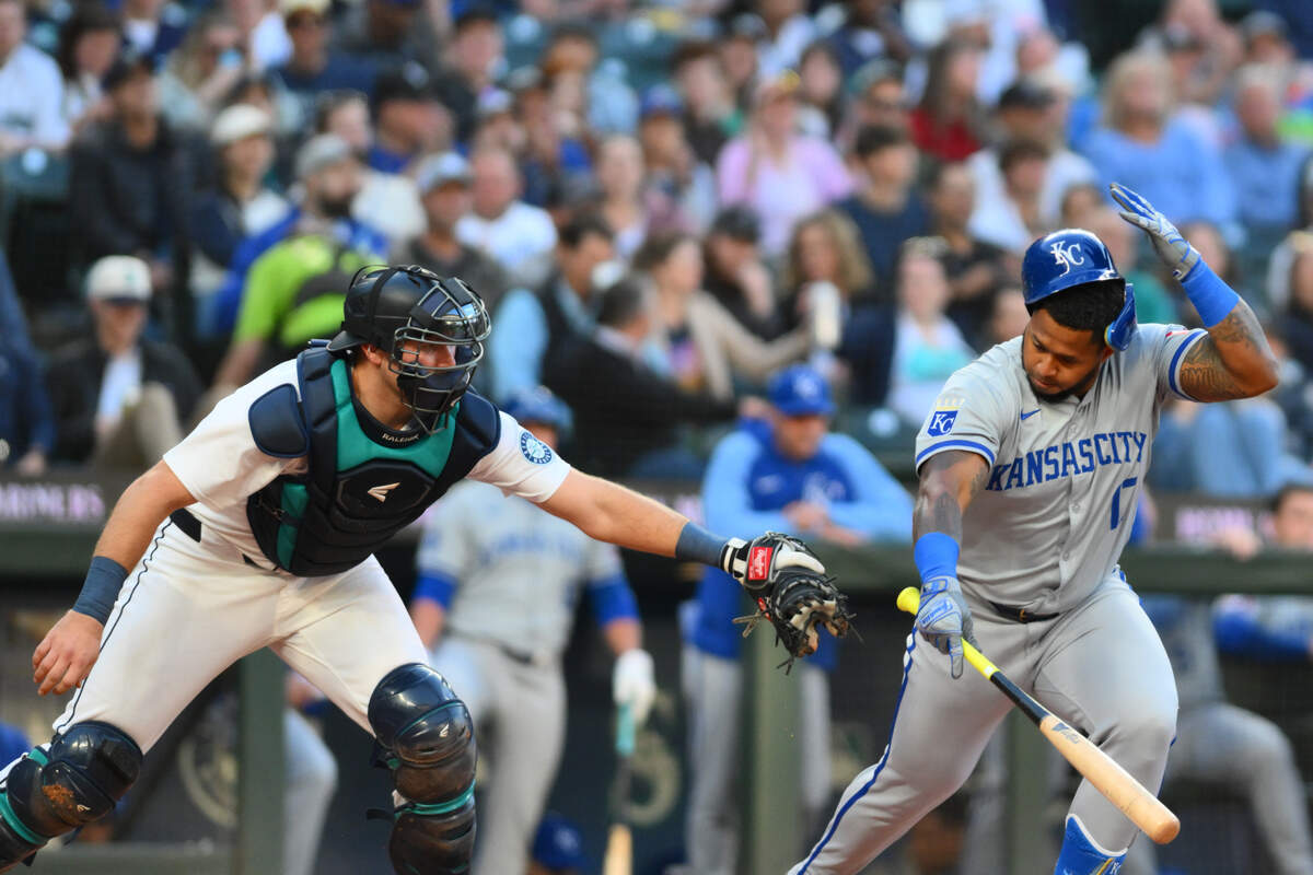 Kansas City Royals designated hitter Nelson Velazquez avoids a tag by Seattle Mariners catcher Cal Raleigh during Tuesday night’s game at T-Mobile Park.