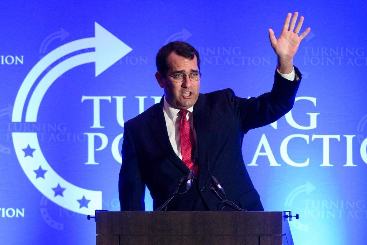 Kansas Attorney General Derek Schmidt acknowledges the crowd as he takes the the stage during the Turning Point Action Unite and Win rally held at the Olathe Conference Center, Embassy Suites.
