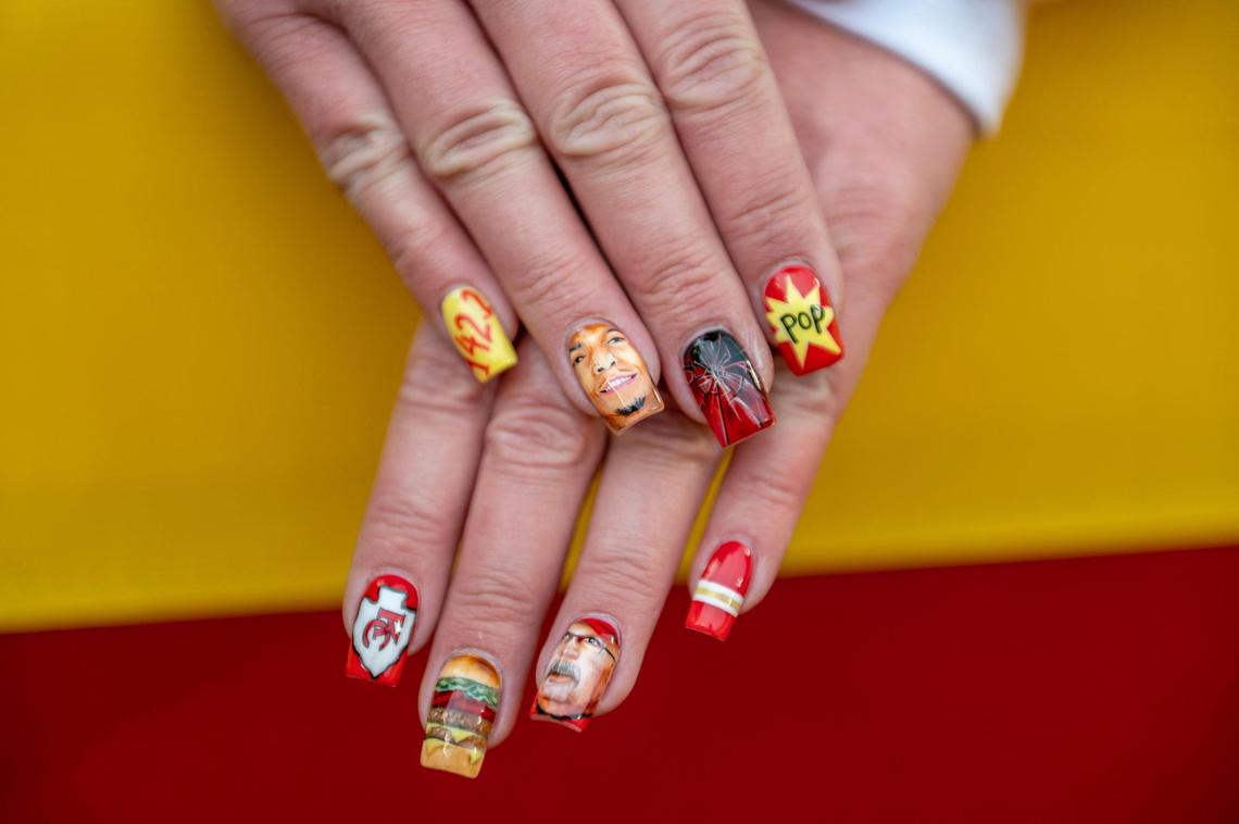 Christina Mulberry shows off her Kansas City Chiefs theme nails while watching players warm up before the AFC Championship Game against the Cincinnati Bengals at GEHA Field at Arrowhead Stadium on Sunday, Jan. 29, 2023, in Kansas City.