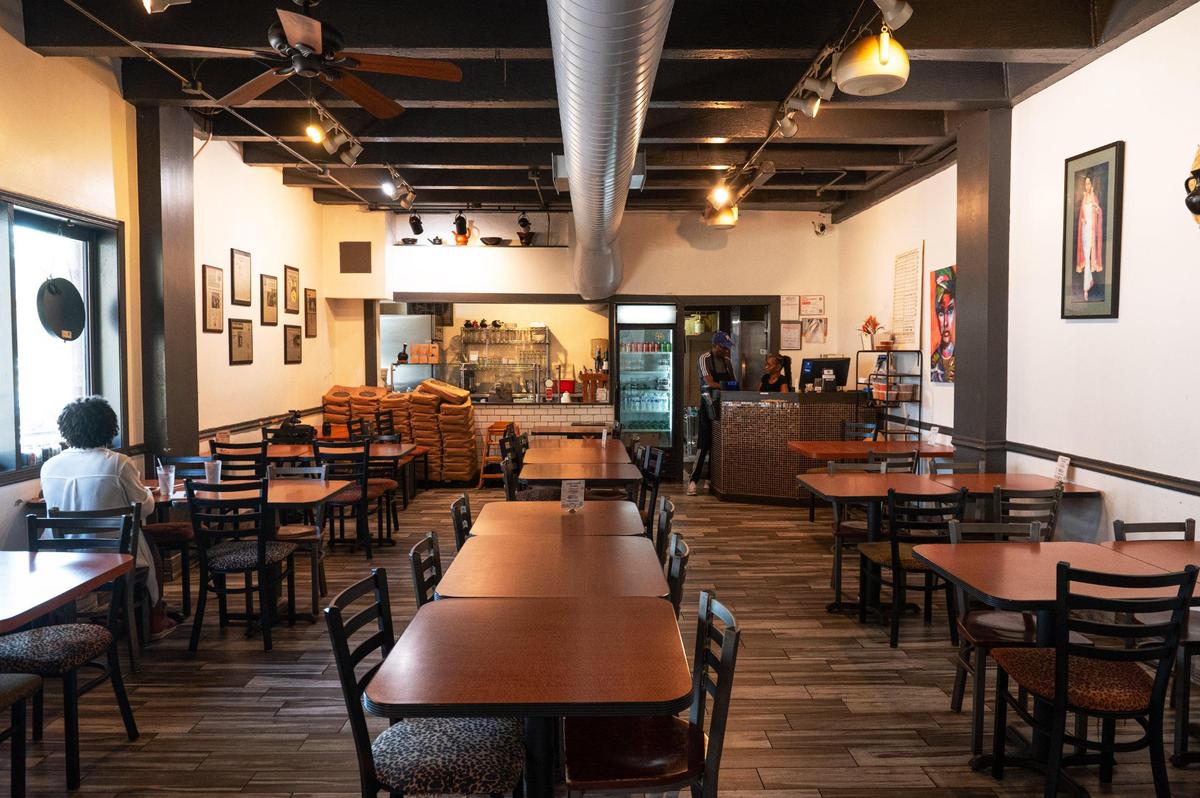 The dining area of Blue Nile Cafe is decorated in colorful African art and crafts.