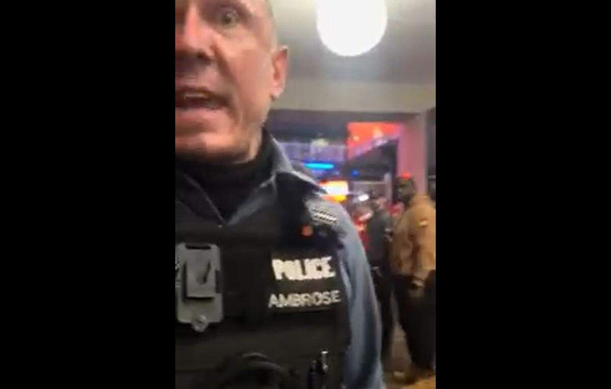 During the arrest of Daysheion Ponds, a Kansas City police officer whose name tag shows the name Ambrose approaches the bystander recording the arrest and threatens to send him to jail.