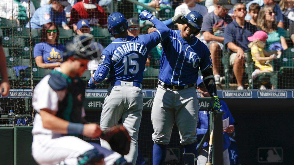 Kansas City Royals’ Whit Merrifield (left) celebrates with teammate Salvador Perez after Merrifield’s solo home run in the first inning against the Seattle Mariners, Saturday, Aug. 28, 2021, in Seattle.