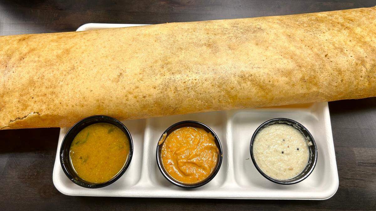 Chettinad’s special dosa dish is so large, it doesn’t fit on the tray it’s served on.