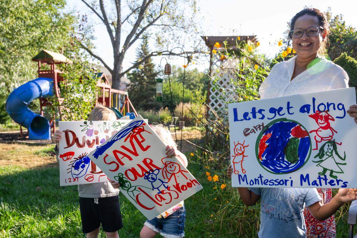 Buddhika Kimmanthudawa with young children holding signs of support at her in-home, licensed Montessori school on Thursday, October 16, 2025, in Leawood. Kimmanthudawa is facing legal threats from her HOA because of parking, traffic complaints and HOA is claiming that she can't operate a business in the HOA.