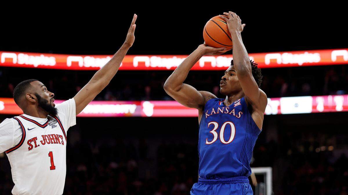 Kansas guard Ochai Agbaji shoots over St. John’s forward Aaron Wheeler in the game on Friday, Dec. 3, 2021, in Elmont, N.Y.