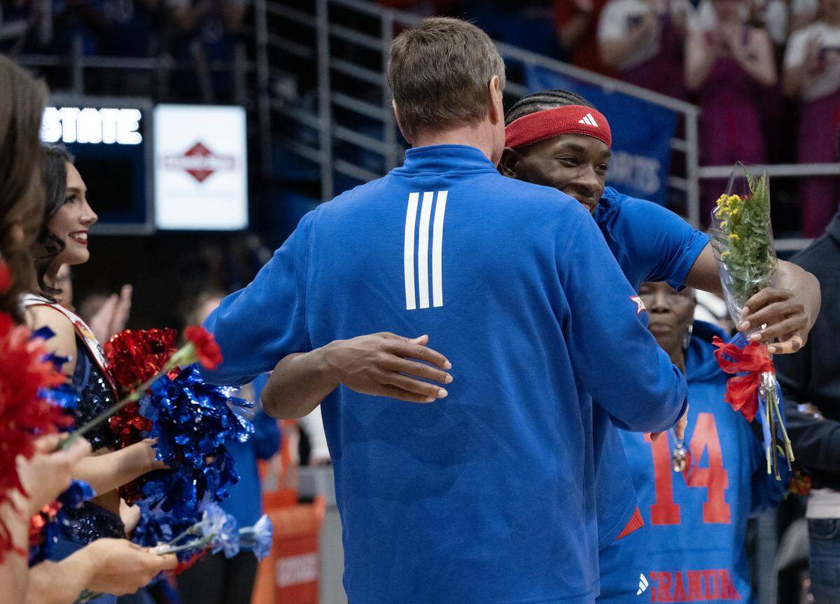 Kansas Jayhawks guard Melvin Council Jr. (14) hugs coach Bill Self as seniors were being honored before the KU-KSU game at Allen Fieldhouse on Saturday, March 7, 2026, in Lawrence, Kansas.