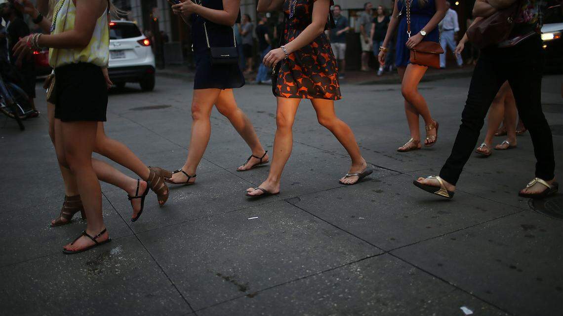 Women wlaking down the street. (Photo by Mario Tama/Getty Images)