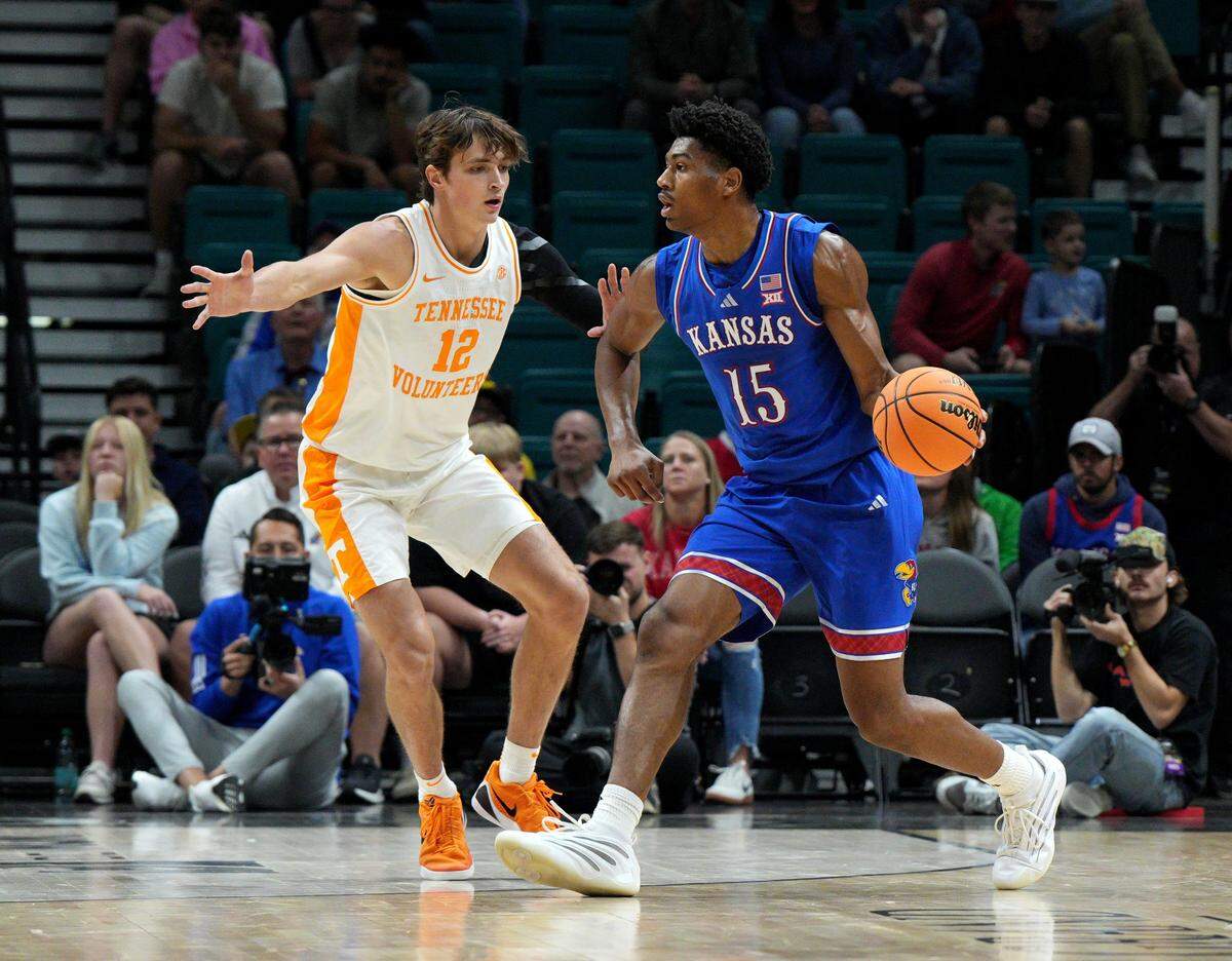 Kansas Jayhawks guard Bryson Tiller, right, looks to pass against Cade Phillips of the Tennessee Volunteers during a Players Era men’s basketball tournament game at the MGM Grand Garden Arena in Las Vegas on Wednesday, Nov. 26, 2025.
