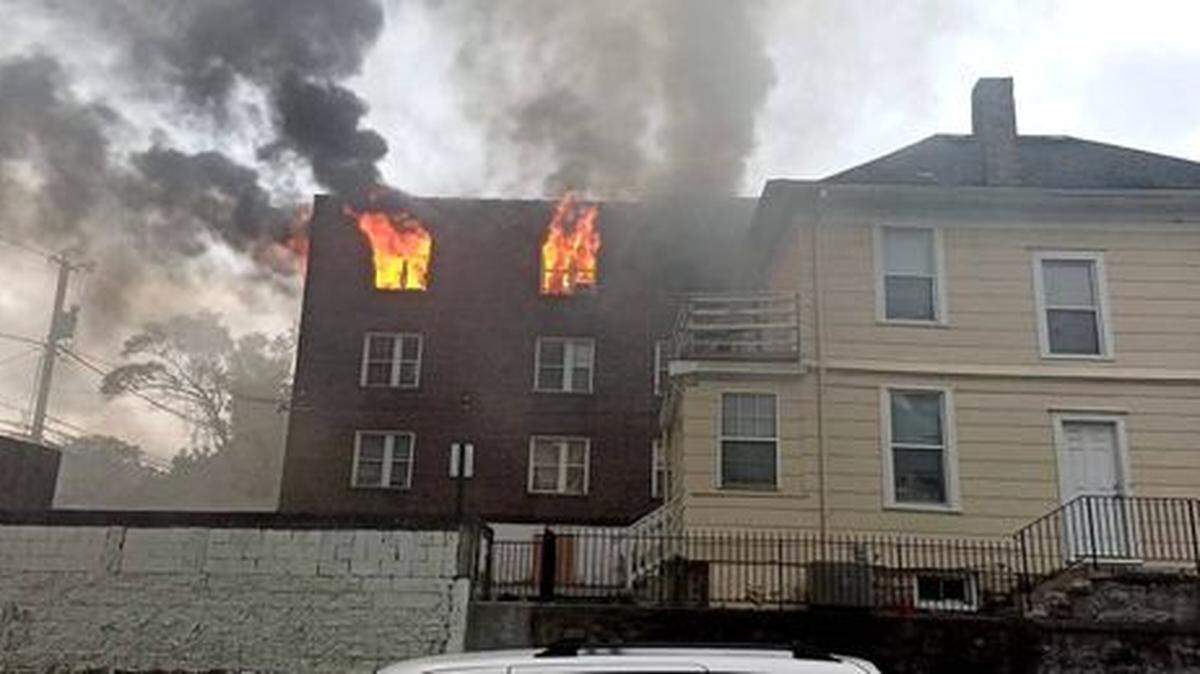 Flames shoot out of the windows of a three-story apartment building that was supposed to be vacant near the southeast corner of North Lawn and Scarritt avenues in Kansas City’s Northeast area Wednesday evening. Five people, none who were tenants, were rescued from the building, a spokesman for the Kansas City Fire Department said.