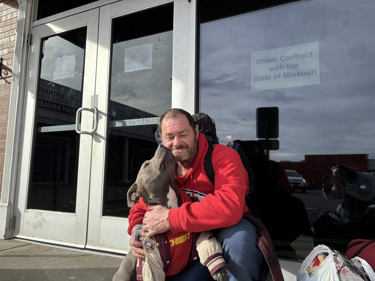 Billy Meier and his dog Blue pose outside the now-closed Kansas City DMV on Jan. 13. Meier took the bus to the DMV, between Troost and Paseo, to get a new ID. He wasn’t sure how he would get to another DMV. 