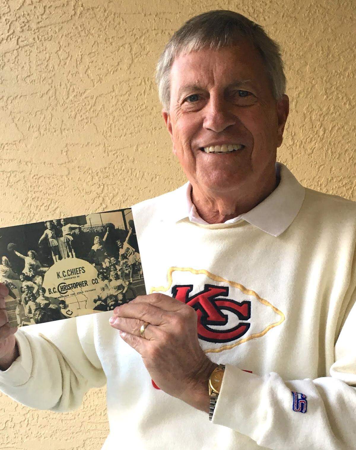 Larry Euston of Leawood, in a photo from 2020, holds a picture of himself at age 19 in 1967 as a member of the Kansas City Chiefs cheerleading squad at Super Bowl I in Los Angeles.