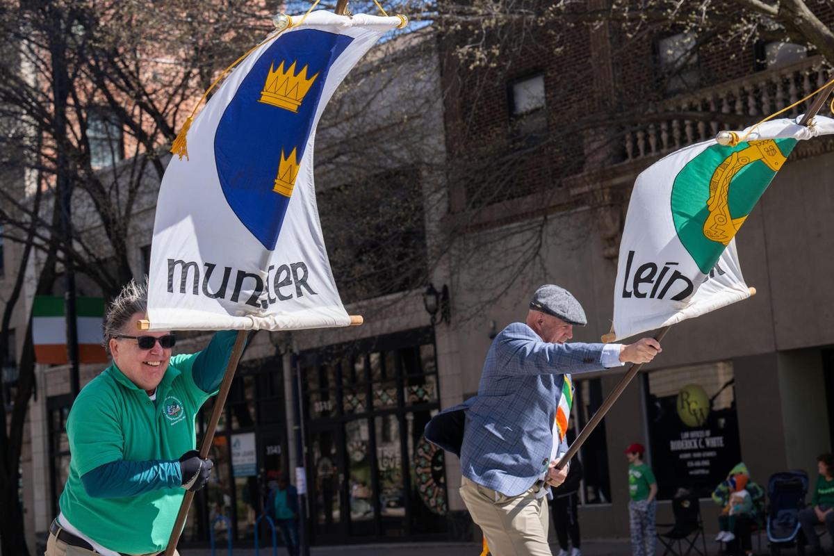 Men with flags representing their clans fight against the wind during the Kansas City St. Patrick’s Day Parade on Monday, March 17, 2025.