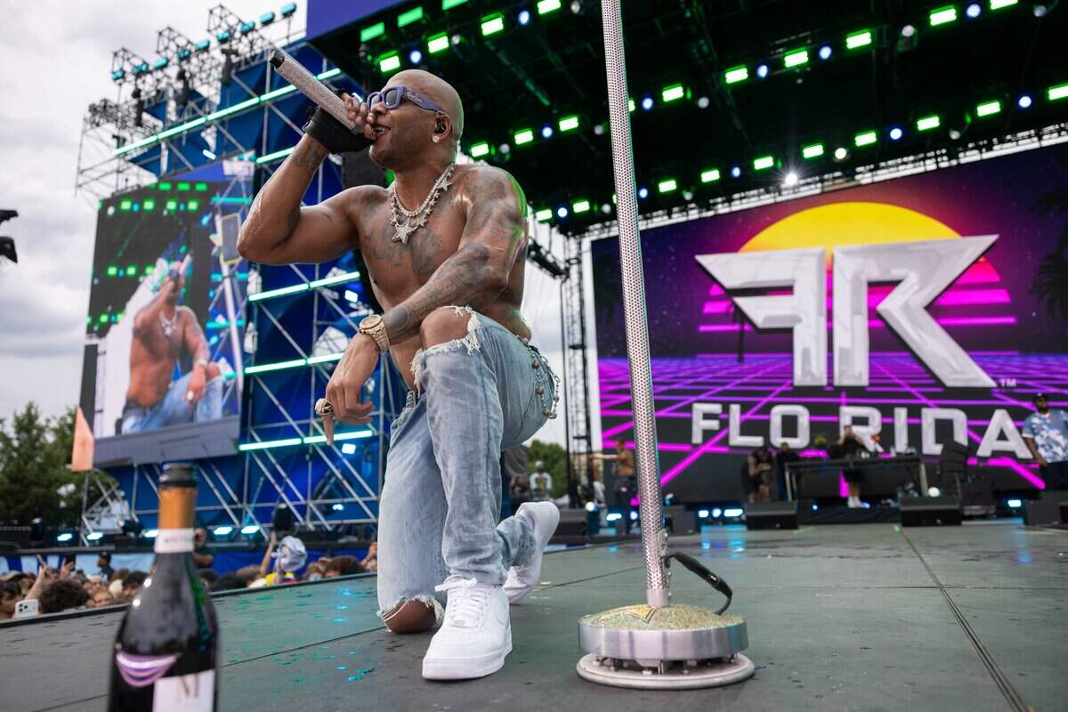 Flo Rida kneels on stage during their FIFA Fan Fest concert at Fan Fest on Friday, June 19, 2026.