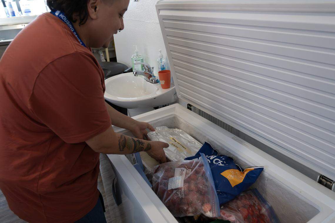 Anali Otazo, program manager, showcases the food stored in a freezer for residents at Teresa's Place on Thursday, Sept. 11, 2025, in Kansas City. The shelter, formerly known as Pride Haven, recently underwent renovations and rebranding.